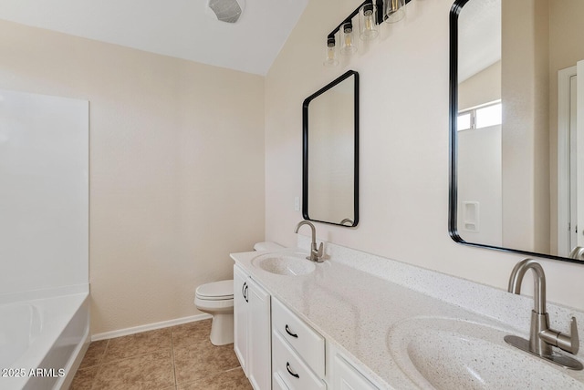 bathroom with vanity, toilet, a bathing tub, and tile patterned flooring