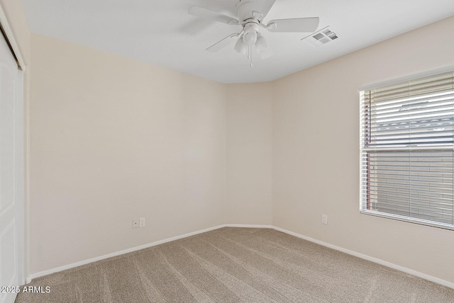 spare room featuring carpet flooring and ceiling fan