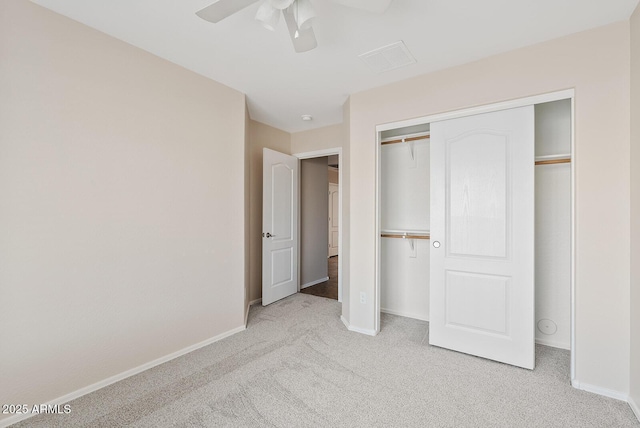 unfurnished bedroom with light carpet, a closet, and ceiling fan