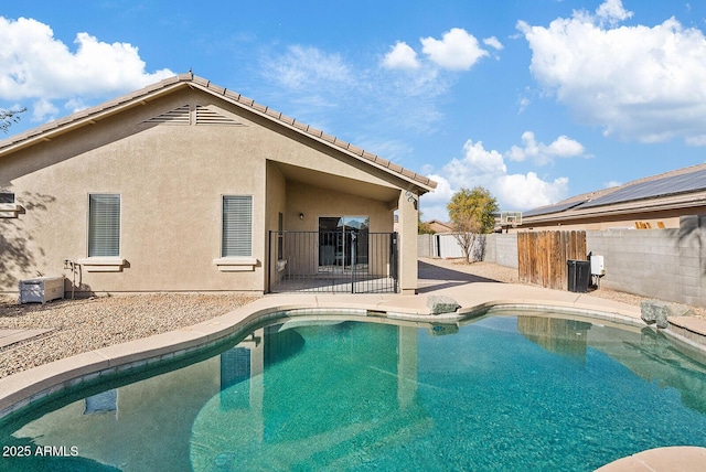 view of swimming pool with cooling unit and a patio area