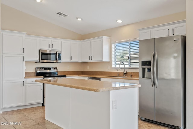 kitchen with white cabinetry, sink, a kitchen island, and appliances with stainless steel finishes