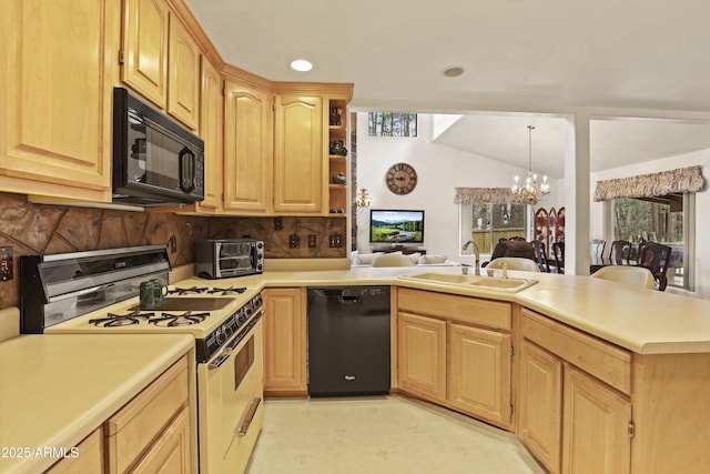 kitchen featuring a peninsula, light brown cabinetry, black appliances, a chandelier, and a sink