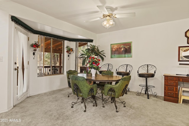 dining area with carpet floors and a ceiling fan