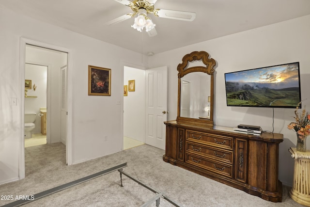 carpeted bedroom featuring ceiling fan and ensuite bathroom