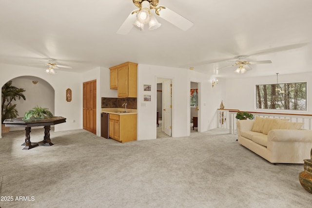 living area featuring ceiling fan and light colored carpet