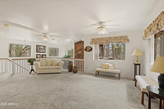 carpeted living room with a ceiling fan and a healthy amount of sunlight