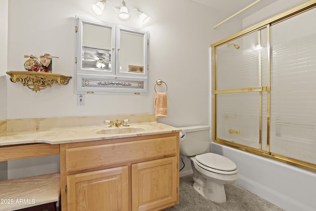 bathroom with toilet, bath / shower combo with glass door, and vanity