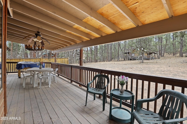 wooden terrace with ceiling fan and outdoor dining space