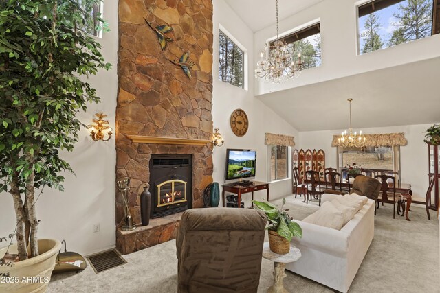 living area featuring a chandelier, a stone fireplace, a high ceiling, carpet flooring, and visible vents