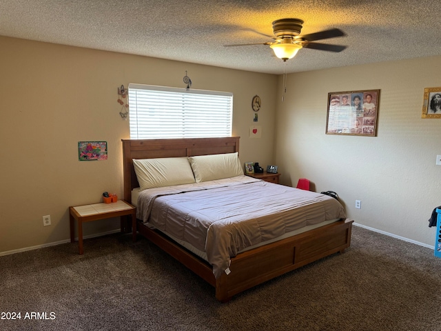 carpeted bedroom with ceiling fan and a textured ceiling