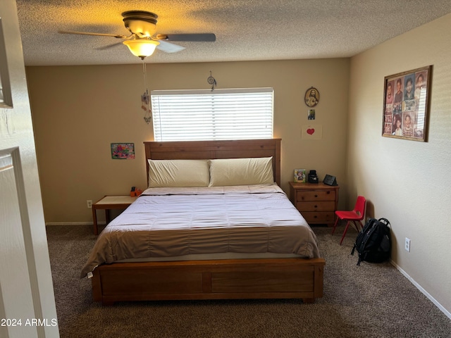 carpeted bedroom featuring ceiling fan and a textured ceiling