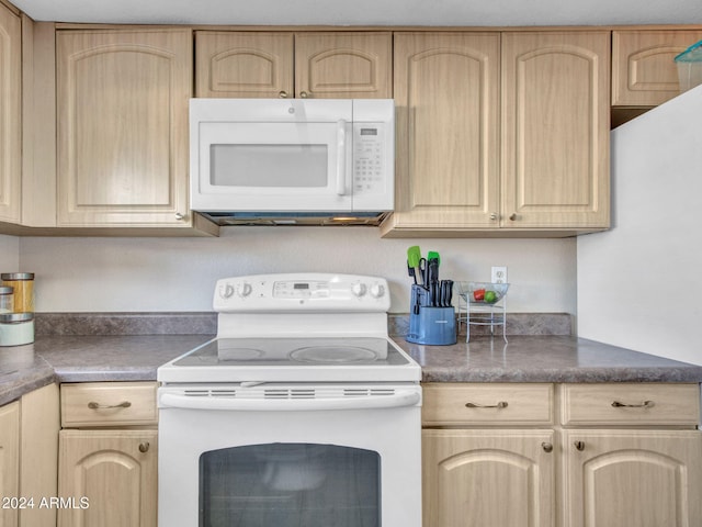 kitchen with light brown cabinetry and white appliances