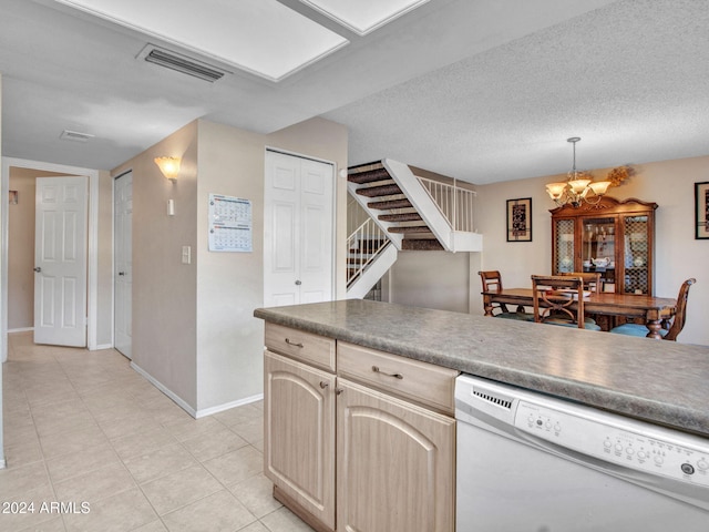 kitchen with light brown cabinets, white dishwasher, decorative light fixtures, a chandelier, and a textured ceiling