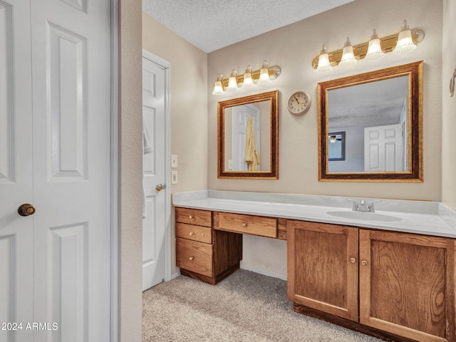 bathroom with vanity and a textured ceiling