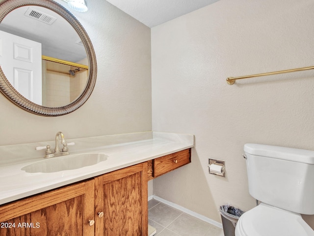 bathroom with vanity, toilet, a textured ceiling, and tile patterned flooring