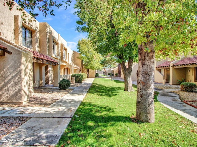 view of property's community with a lawn