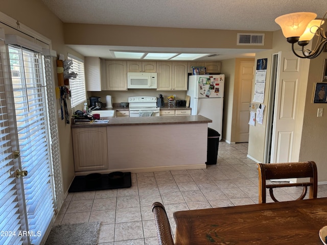 kitchen with white appliances, sink, a textured ceiling, kitchen peninsula, and light tile patterned floors