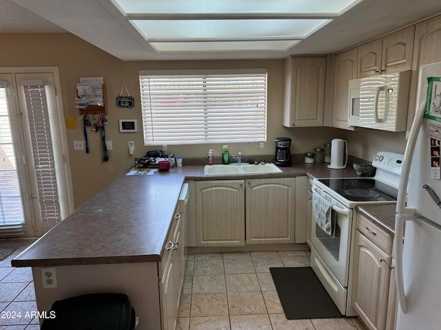 kitchen with white appliances, light brown cabinetry, sink, kitchen peninsula, and light tile patterned floors