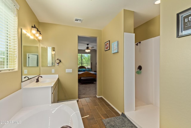 5218 W Lydia Ln, Laveen, AZ 85339 - bathroom with walk in shower, ceiling fan, ensuite bath, wood finish floors, and vanity
