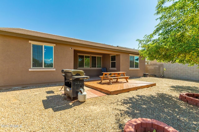 5218 W Lydia Ln, Laveen, AZ 85339 - back of house featuring a wooden deck, fence, a fire pit, and stucco siding