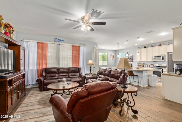 5218 W Lydia Ln, Laveen, AZ 85339 - living area with visible vents, light wood-type flooring, recessed lighting, and a ceiling fan