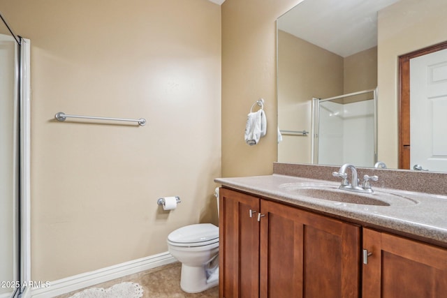 bathroom with vanity, tile patterned flooring, a shower with shower door, and toilet