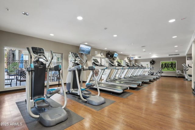 exercise room with wood-type flooring