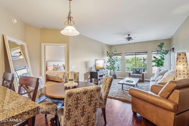 dining space featuring dark wood-type flooring and ceiling fan