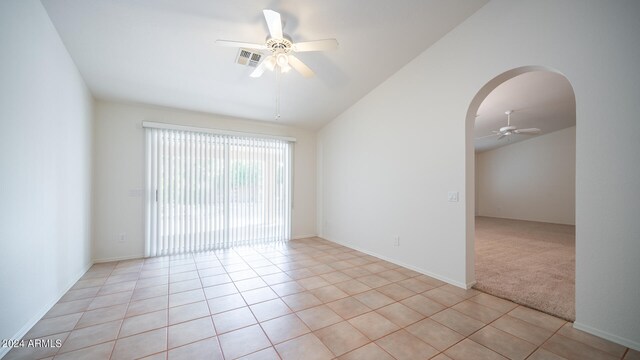 carpeted empty room featuring ceiling fan and lofted ceiling