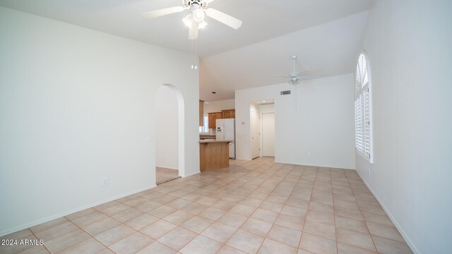 tiled empty room featuring ceiling fan