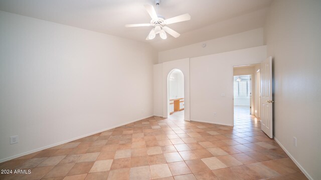 tiled empty room featuring ceiling fan