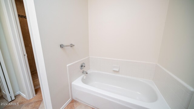 bathroom featuring tile patterned floors and a tub