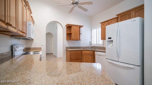 kitchen with ceiling fan, sink, vaulted ceiling, white appliances, and light tile patterned floors