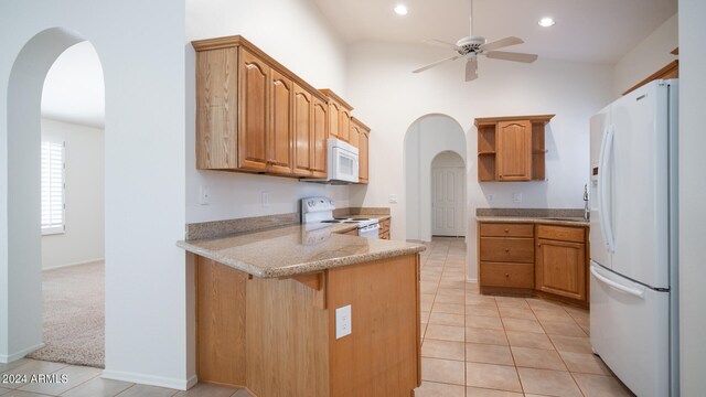 kitchen featuring ceiling fan, light tile patterned flooring, white appliances, and sink