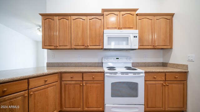 kitchen featuring ceiling fan, white appliances, and kitchen peninsula