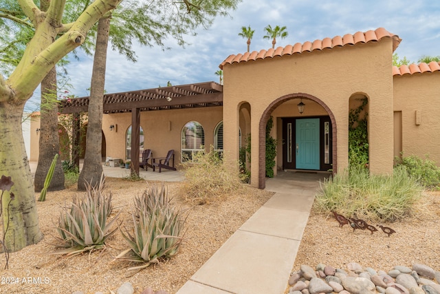 doorway to property with a patio area