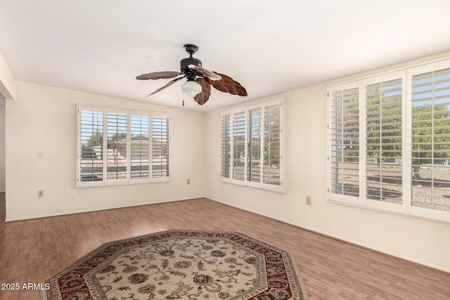 unfurnished room with a ceiling fan and wood finished floors