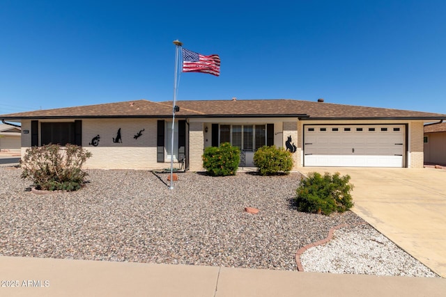 ranch-style home with driveway, brick siding, a shingled roof, and an attached garage