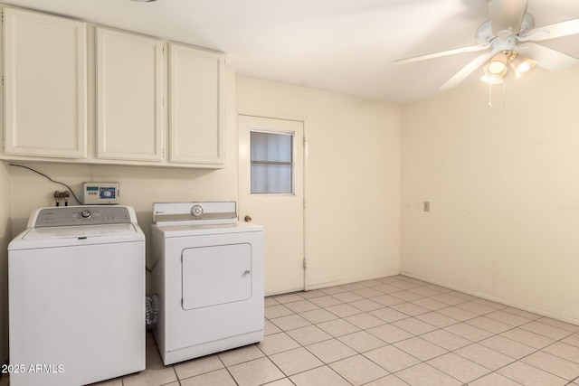 clothes washing area featuring ceiling fan, washer and dryer, and cabinet space