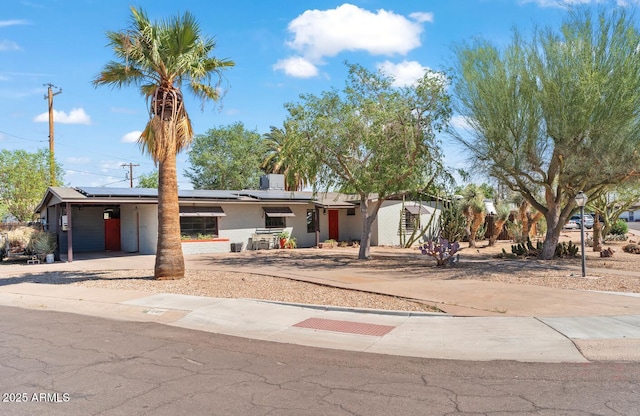 1749 W Monterosa St, Phoenix, AZ 85015 - view of front of home with roof mounted solar panels, concrete driveway, and a carport