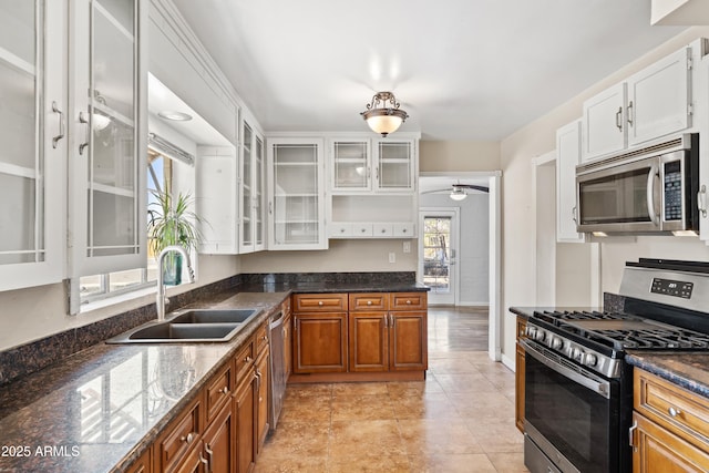 1749 W Monterosa St, Phoenix, AZ 85015 - kitchen featuring stainless steel appliances, a ceiling fan, glass insert cabinets, white cabinetry, and brown cabinetry