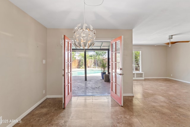 1749 W Monterosa St, Phoenix, AZ 85015 - empty room featuring french doors, a chandelier, and tile patterned floors