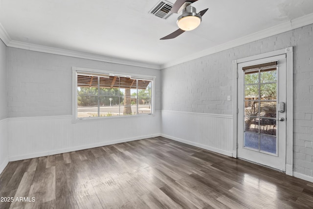 1749 W Monterosa St, Phoenix, AZ 85015 - empty room featuring healthy amount of natural light, a ceiling fan, ornamental molding, wood finished floors, and wainscoting