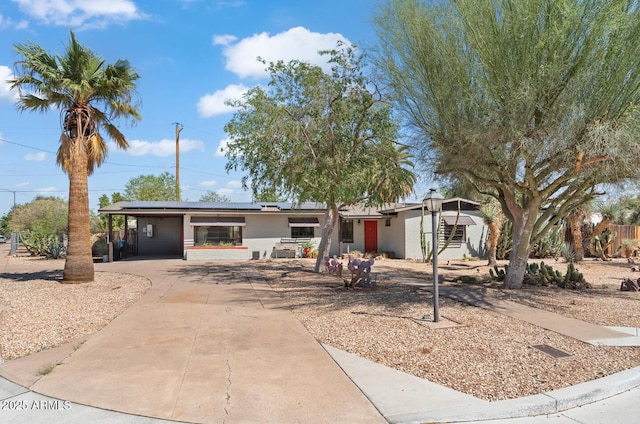 1749 W Monterosa St, Phoenix, AZ 85015 - view of front of home featuring driveway, roof mounted solar panels, and an attached carport