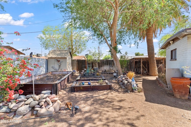 1749 W Monterosa St, Phoenix, AZ 85015 - fenced backyard featuring a garden and a storage unit