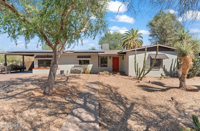 1749 W Monterosa St, Phoenix, AZ 85015 - rear view of property featuring brick siding, solar panels, and a carport
