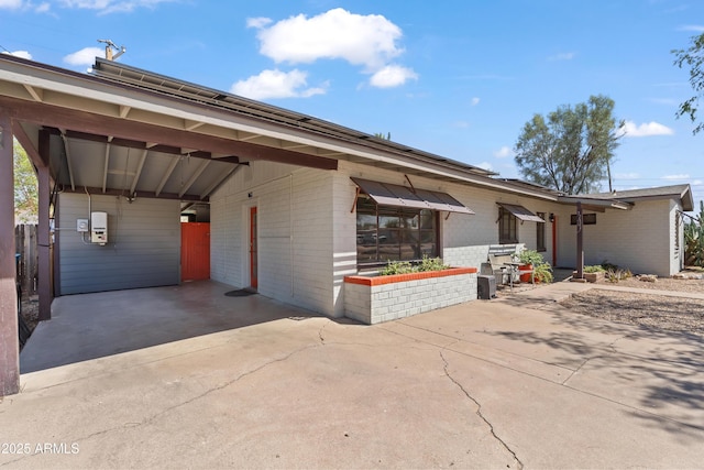 1749 W Monterosa St, Phoenix, AZ 85015 - view of front of house with brick siding, concrete driveway, and an attached carport