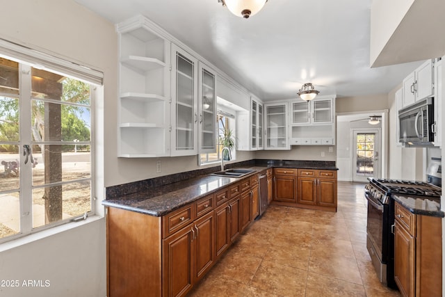 1749 W Monterosa St, Phoenix, AZ 85015 - kitchen with open shelves, stainless steel appliances, glass insert cabinets, brown cabinets, and dark stone counters