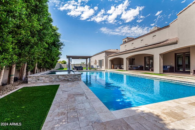 view of swimming pool featuring french doors, a patio area, an in ground hot tub, a fenced backyard, and an outdoor living space