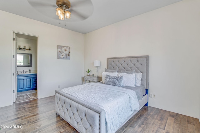 bedroom with ceiling fan, sink, ensuite bath, and dark wood-type flooring